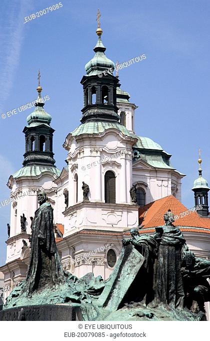 The monument to the 15th Century religious reformer and local hero, Jan Hus, in front of the Baroque Church of St Nicholas in the Old Town Square