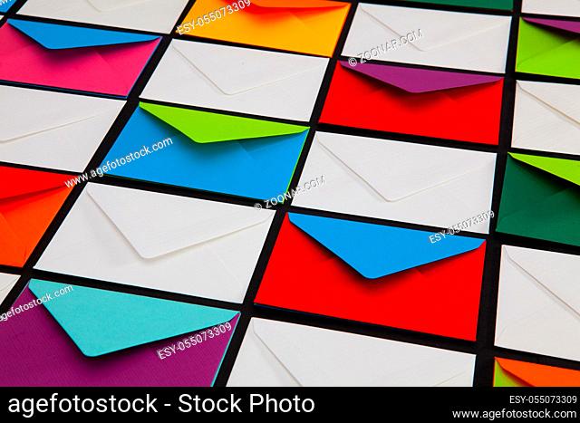 Composition with white and colored envelopes on the table. The photo suitable for various holidays and anniversaries