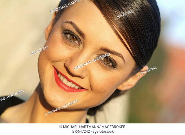 Portrait of a young Mediterranean-looking woman in evening light