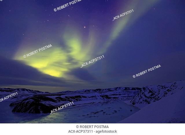 Aurora borealis or northern lights over an unnamed lake along the Dempster Highway, Northwest Territories, Canada