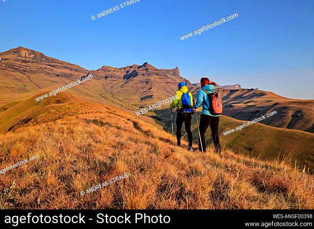Woman and man hiking at KwaZulu-Natal, Drakensberg, South Africa