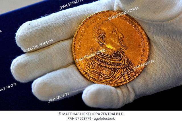 An employee holds the heaviest gold coin with a weight of 348, 37 gramm of the Dresden coin collection belonging to the Dresden State Art collection in Dresden