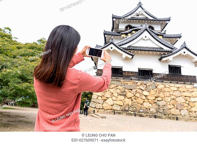 Woman taking photo on Hikone Castle