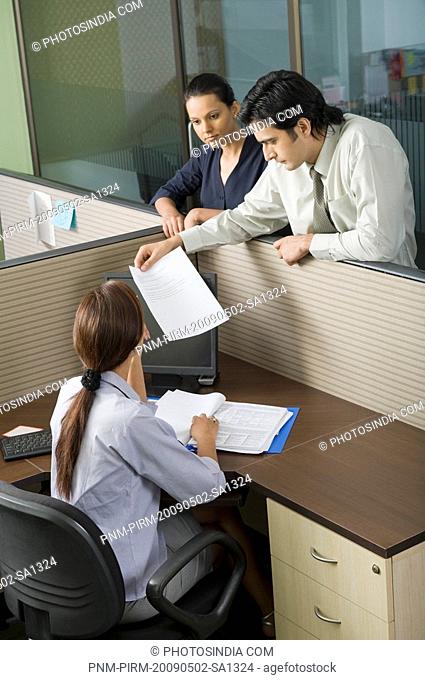 Business executives looking at a document in an office