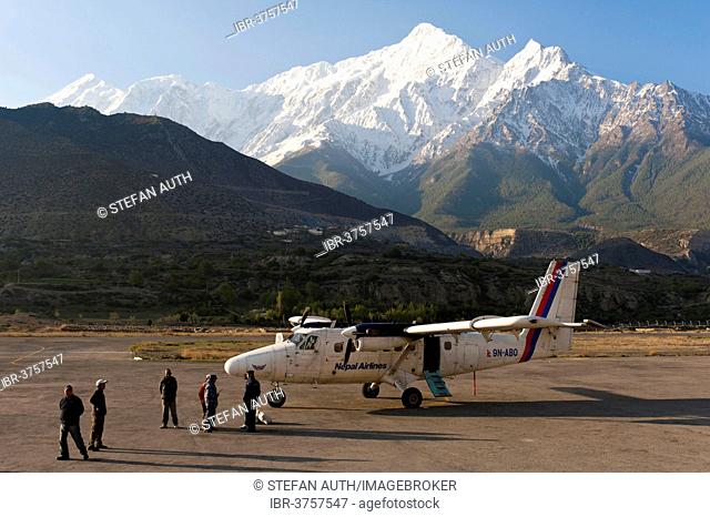 Propeller aircraft DHC-6 Twin Otter at Jomsom airport, behind the snow-capped mountain Nilgiri North, Lower Mustang, Nepal