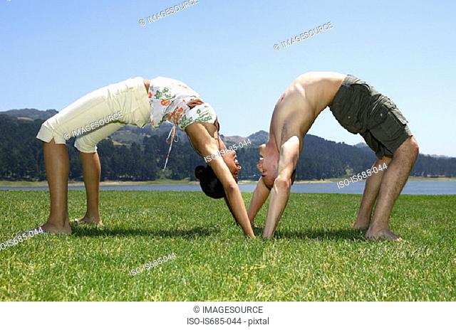 Man and woman bending over backwards