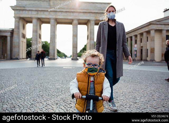 Mother and son walking in Brandenburg gate in Berlin in Corona days