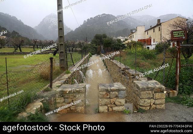 28 February 2023, Spain, Caimari: A torrent flows through the village at the foot of the Serra de Tramuntana mountain range in northwest Mallorca
