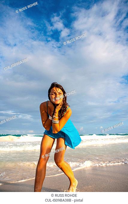 Young woman in sundress playing on beach, Tulum, Quintana Roo, Mexico