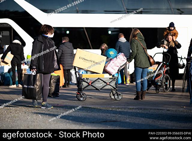 02 March 2022, Lower Saxony, Hanover: Soccer: DFB Cup, quarterfinals: Hannover 96 - RB Leipzig at the HDI Arena. People hand in relief supplies for the people...