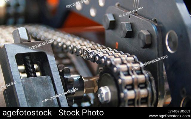 Caterpillar transmission - mechanism of machinery manufacturing on extrusion plant - chemistry industry, close up