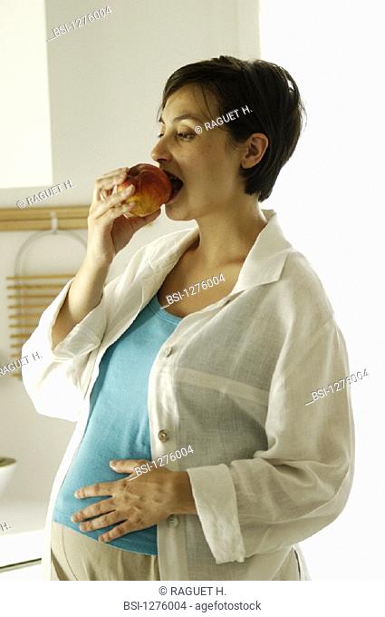 PREGNANT WOMAN EATING<BR>Model.<BR>Woman 8-months-pregnant