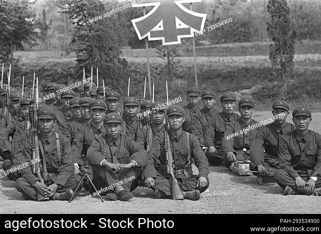 Chinese soldiers of the People's Liberation Army (PLA) sit on a training ground, with rifles and bayonets, July 26, 1972. - Beijing/China