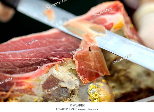 Cutting slices of cured iberian ham
