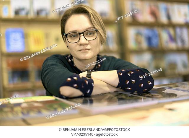 woman indoors in book store, in Munich, Germany