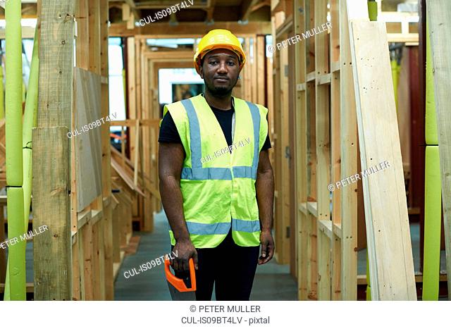 Male higher education carpentry student in college workshop, portrait