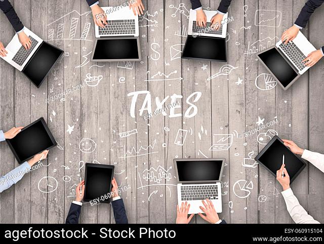 Group of business people working in office with TAXES inscription, coworking concept
