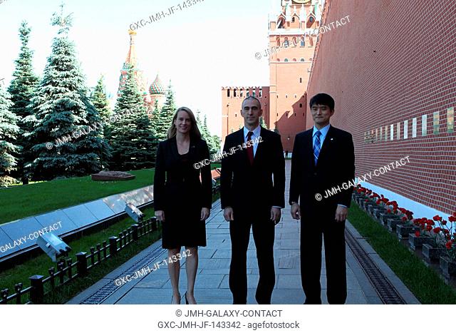 At the Kremlin Wall in Moscow's Red Square, Expedition 48-49 prime crew members Kate Rubins of NASA (left), Anatoly Ivanishin of Roscosmos (center) and Takuya...