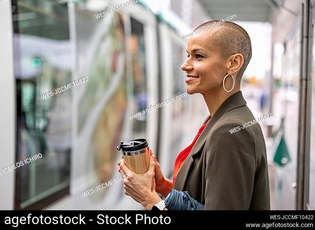 Woman boarding tram at station platform