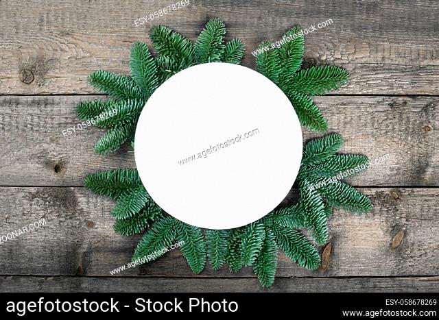 Christmas circle frame of natural fir tree branches with copy space for text