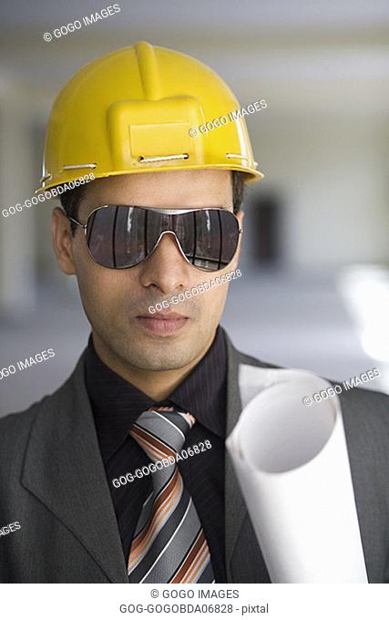 Businessman wearing sunglasses and a hardhat