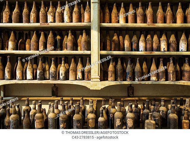 Showroom with old, dust covered sherry bottles at the Bodega Gonzalez Byass in Jerez de la Frontera. Cadiz province, Andalusia, Spain