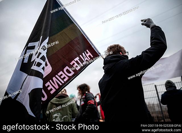 18 January 2020, North Rhine-Westphalia, Marl: A participant in a counter-demonstration holds a flag. One of the topics at the AfD party conference will be the...