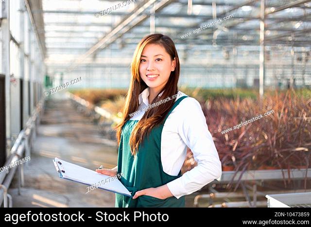 young beautiful chinese woman works in green field
