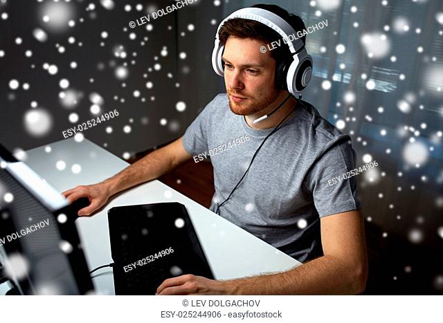 technology, gaming, entertainment, let's play and people concept - young man in headset with pc computer playing game at home and streaming playthrough or...