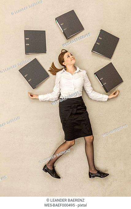 Businesswoman juggling with files