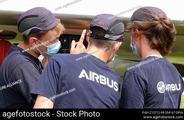 12 July 2021, Hamburg: The trainees who restore and maintain the museum aircraft ""VFW614"" look at the wing during a press appointment