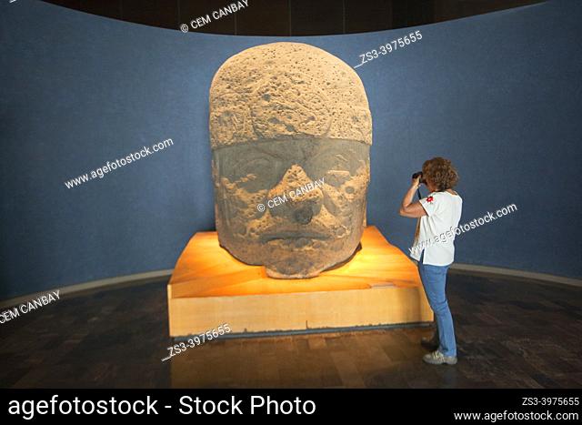 Tourist taking photos of a Olmec colossal head in National Museum Of Anthropology-Museo Nacional De Antropologia, Mexico City, Mexico, Central America