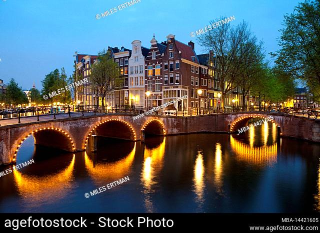 Historic buildings and bridges along Keizersgracht Canal at dusk, Amsterdam, North Holland, Netherlands