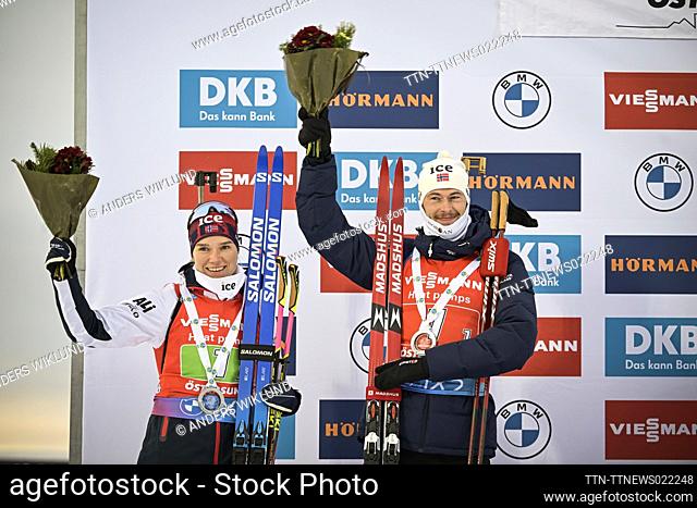Norway's Juni Arnekleiv (L) and Sturla Holm Laegreid celebrate on the podium after placing second in the Single Mixed Relay event of the IBU World Cup Biathlon...