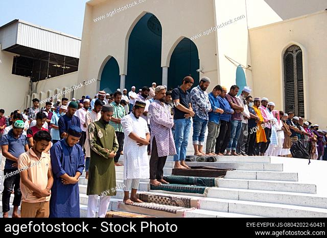 DHAKA, BANGLADESH - APRIL 8, 2022: Muslim devotees offer Jummah prayer during the holy month of Ramadan outside of the Baitul Mukarram National Mosque