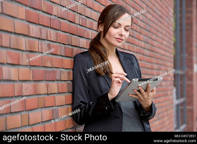 Business woman holds a tablet PC