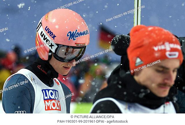 01 March 2019, Austria, Seefeld: Ski jumping, world championship, normal hill, men, 2nd round. Karl Geiger (l) from Germany reacts in the run next to Richard...