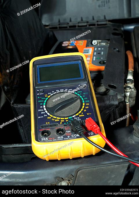 Multimeter set up and ready for taking car battery voltage measurement