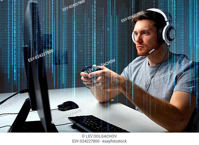 technology, gaming, entertainment, let&#39;s play and people concept - young man in headset with controller gamepad playing computer game at home and streaming...