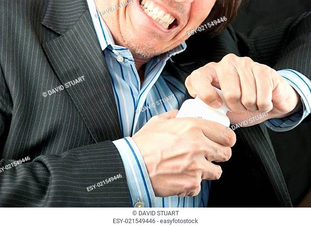 Frustrated Businessman Trying To Open Pill Bottle