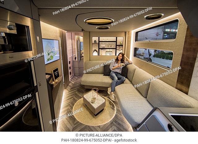 24 August 2018, Germany, Düsseldorf: Hilal sits in a concept caravan from Bürstner. The world's largest camping fair Caravan Salon will take place from 25