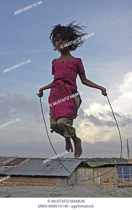 A girl skips at the Kurmitola Bihari Camp in Dhaka Bangladesh August 04, 2008