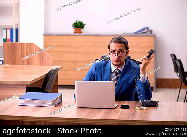 Young employee sitting at workplace