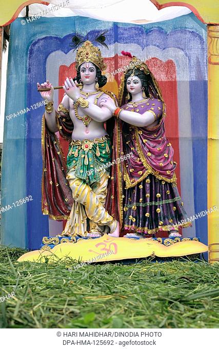 Janmashtami festival or Lord Krishna birthday celebration carnival clay idols of  Krishna and Radha displayed on truck ; Jabalpur ; Madhya Pradesh ; India