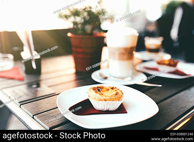 portuguese pastry pastel de nata on wooden table with hot coffee berverage