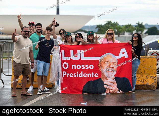 30 December 2022, Brazil, Brasilia: ""Lula - our President"" is written on a poster held by supporters of future Brazilian President Lula da Silva on the...