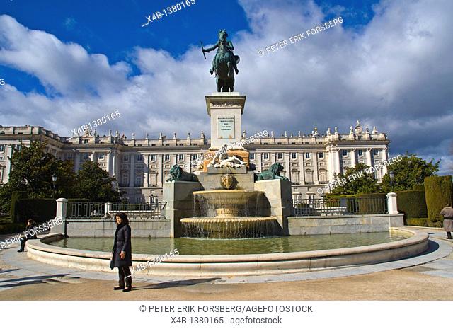 Tourist posing in front of statue of Felipe IV and Palacio Real royal palace Plaza de Oriente square central Madrid Spain Europe