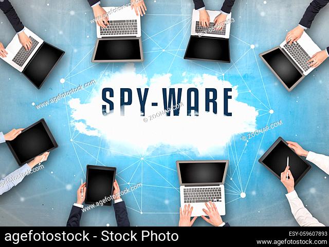 Group of people having a meeting with SPY-WARE insciption, web security concept