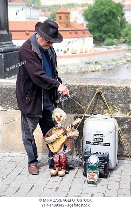 An entertainer with his marionette on the Charles Bridge in Prague