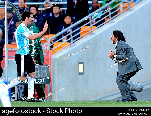 Argentina's coach Diego Armando Maradona celebrates with three-time-goalscorer Gonzalo Higuain during the 2010 FIFA World Cup group B match between Argentina...
